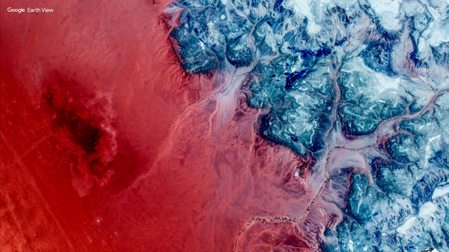 Earth View satellite photo of a red and blue coastline