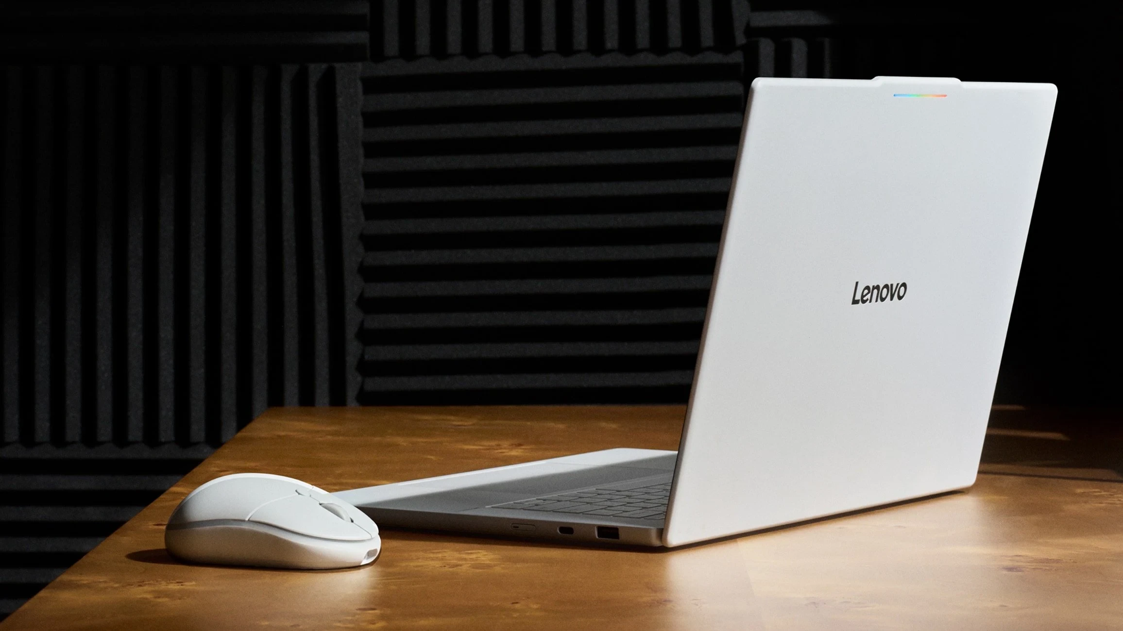Lenovo Googlebook laptop with the bundled Lenovo AI mouse on a wooden table