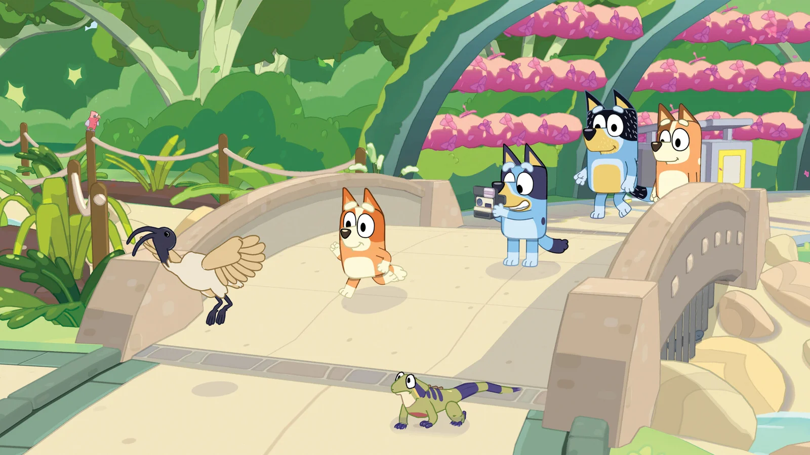 Bluey's Happy Snaps screenshot of Bluey taking a photo with Bingo, Bandit and Chilli