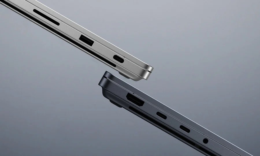 Side edges of two Surface Laptop Ultra units: a Platinum one showing the SD card reader, USB-A and USB-C ports, and a Nightfall one showing HDMI, two USB-C ports and the headphone jack